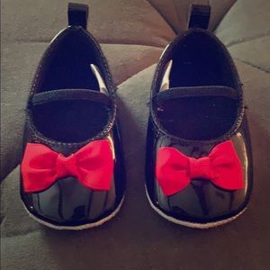 Black flats with elastic strap and red bow